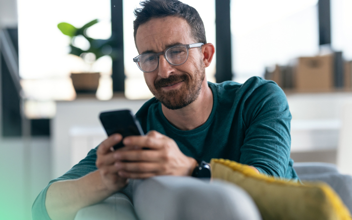 Man smiling at his phone. 