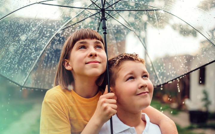 two children under umbrella