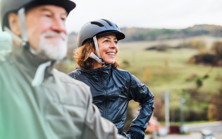 two older adults bike riding
