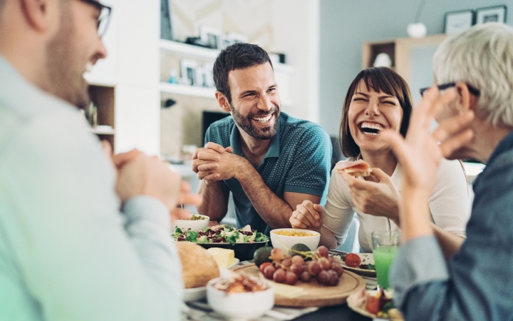a group of happy people is having food and talking about super tax deduction