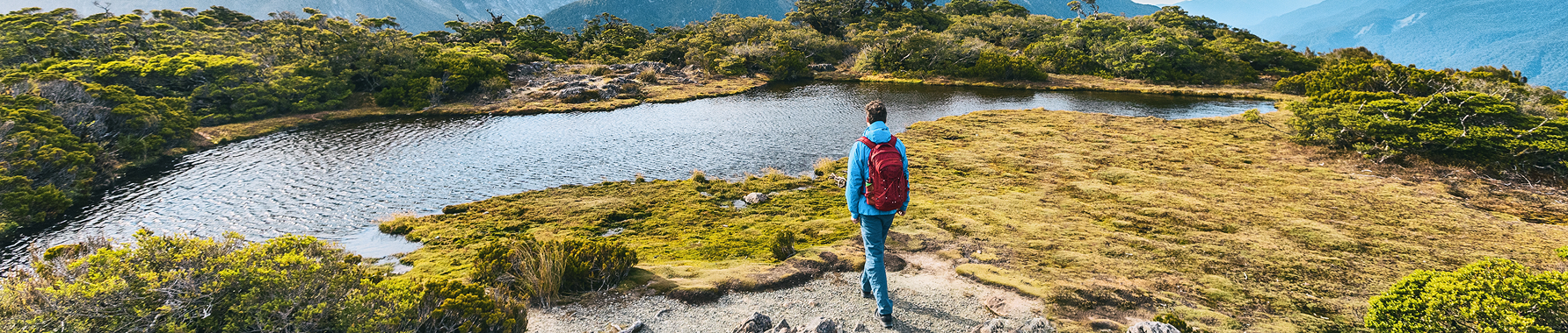 A person is travelling and enjoying mountain and lake view