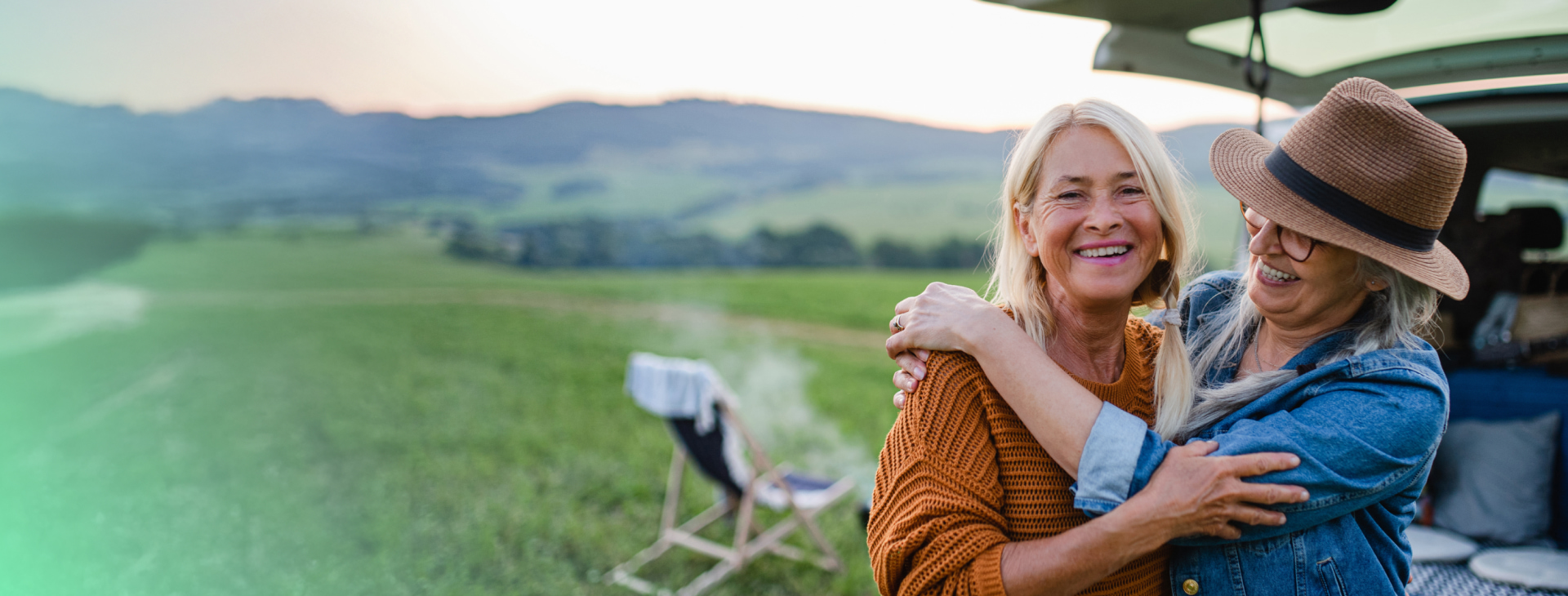 two elderly women are smiling and hugging each other