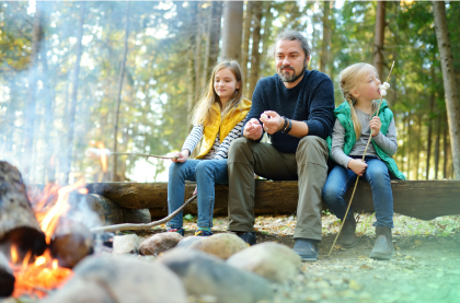 A happy man with two children are enjoying their beautiful time outside