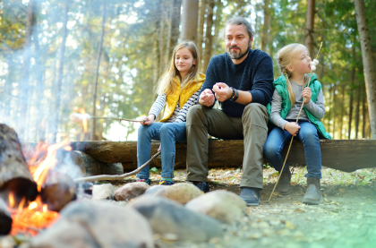 A happy man with two children are enjoying their beautiful time outside