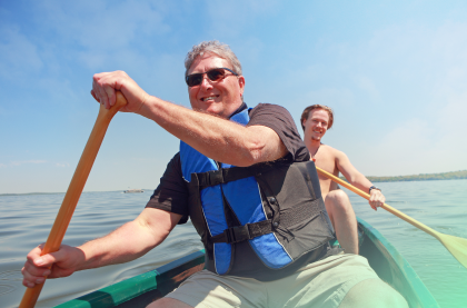 Two happy men enjoying kayaking
