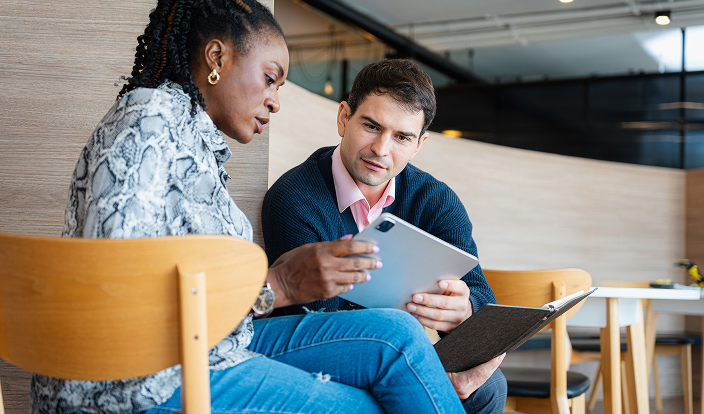 two people are talking about financial planning assistance